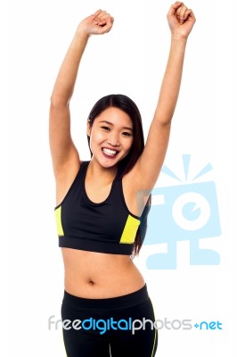 Joyous Female Raising Arms In Excitement Stock Photo