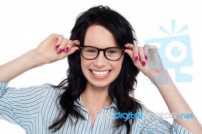 Joyous Woman Holding Her Spectacles Stock Photo