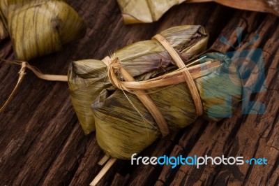 Khao Tom Mat - Thai Dessert - Sticky Rice, Banana And Black Beans Wrapped In Banana Leaf Stock Photo Khao Tom Mat - Thai Dessert - Sticky Rice, Banana And Black Beans Wrapped In Banana Leaf Stock Photo