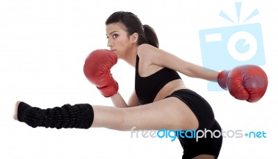 Kickboxing Girl Giving Strong Kick With Her Leg Stock Photo