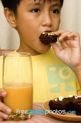 Kid Eating Brownies Stock Photo