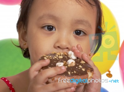 Kid Eating Donut At Party Stock Photo
