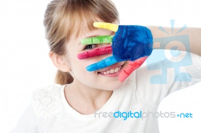 Kid Hiding Face With Her Colored Hand Stock Photo