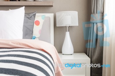 Kid's Bedroom With White Pillows And Lamp On Modern Bed Stock Photo