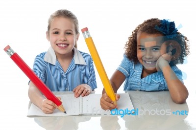 Kids Completing Their Assignment Stock Photo