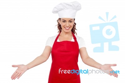 Lady chef showing welcome gesture Stock Photo