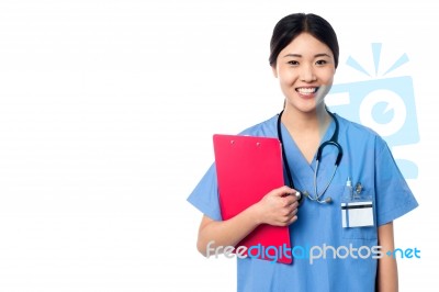 Lady Doctor Holding Clipboard And Posing Stock Photo