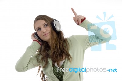 Lady Pointing Out With Headphone Stock Photo