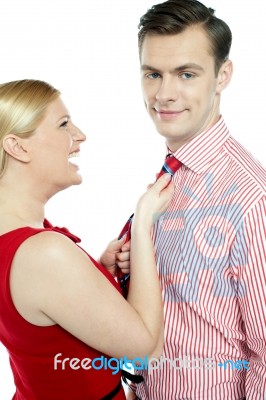 Lady Pulling Tie Her Husband Stock Photo