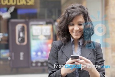 Lady Reading Sms In Street Stock Photo