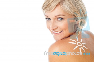 Lady With Sun Tan Lotion On Her Back Stock Photo