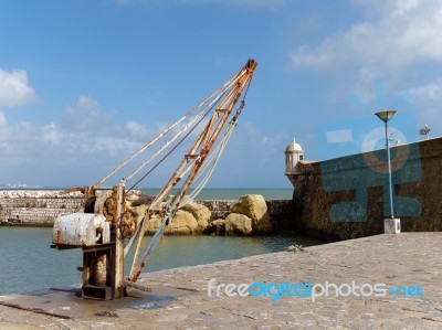 Lagos, Algarve/portugal - March 5 : Old Crane Outside Fort Ponta… Stock Photo