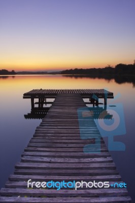 Lake Pier At Sunset Stock Photo