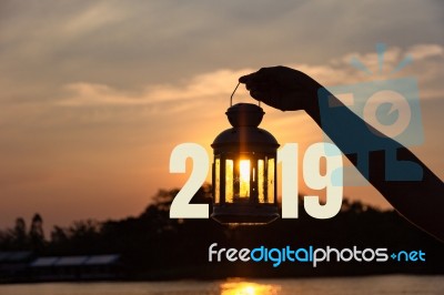 Lamp On Hand In Sunbeam Over Sunset With 2019 . Power And Idea C… Stock Photo