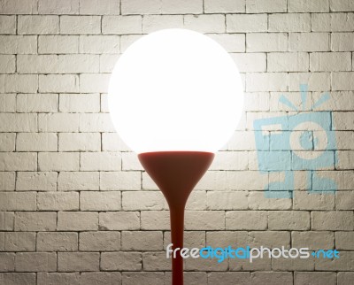 Lamp With Circle Shape On White Bricks Background Stock Photo