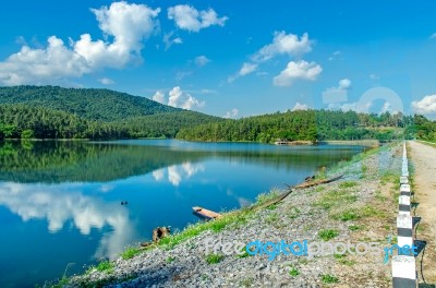 Landscape Of The Dam And Lake On The Mountain With Tree And Forest And The Boat Stock Photo