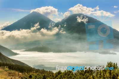 Landscape Of Volcanoes Surrounding Lake Atitlan In Guatemala Stock Photo