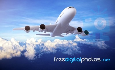 Large Passenger Plane Flying In The Blue Sky Stock Photo