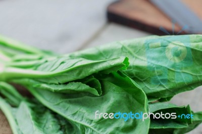 Leaves Of Kale On Wooden Stock Photo