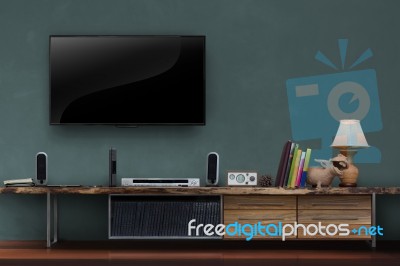 Led Tv On Dark Green Wall With Wooden Media Furniture Stock Photo