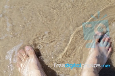 Leg On Sea Water, Top View Stock Photo