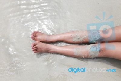 Leg Or Bare Woman Feet In The Ocean On Sand Beach Stock Photo