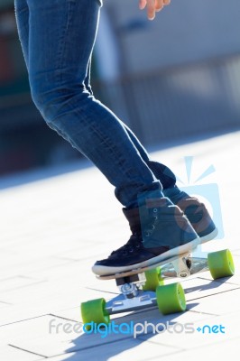 Legs Of Young Boy Skating Down The Street Stock Photo