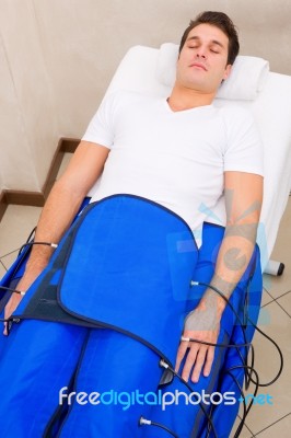 Legs Pressotherapy Machine On Man In Beauty Center Stock Photo