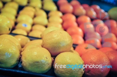 Lemon And Oranges On Produce Shelf Stock Photo