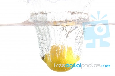 Lemon Dropped In Water Stock Photo