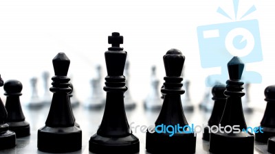 Light And Dark Wooden Chess Pieces On Chess Table Stock Photo