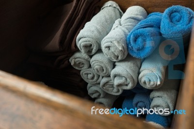 Light Gray And Blue Rolled Spa Massage Towel In The Wooden Box Stock Photo