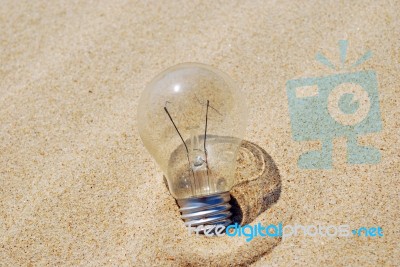 Lightbulb On Sand (global Warming) Stock Photo