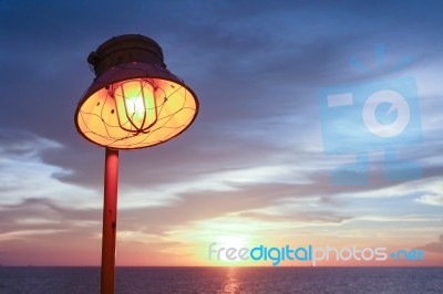 Lighting Of Warm Lamp And Lighting Of Sunset At Sea Stock Photo