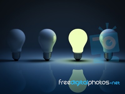 Lit Light Bulb Among Unlit Stock Image