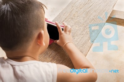 Little Asian Boy Playing Game On Mobile Or Smart Phone Stock Photo