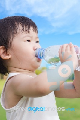 Little Asian Girl  Drinking Water From Plastic Bottle Stock Photo