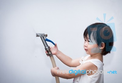 Little Asian Girl Play With Water Hose Stock Photo