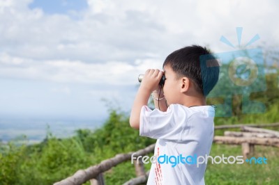 Little Child Look In Binoculars Outdoor In Sunny Summer Day Stock Photo