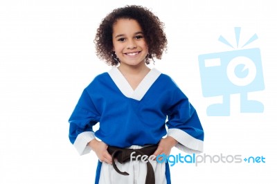 Little Girl Adjusting Her Brown Karate Belt Stock Photo