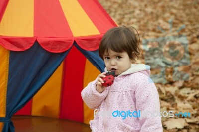 Little Girl Eats  In The Park Stock Photo