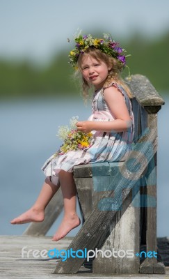 Little Girl On A Bench By A Lake Stock Photo