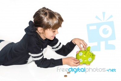 Little Girl Saving Money In Piggy Bank Stock Photo