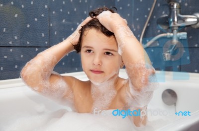 Little Girl Washes Her Head In The Bath Stock Photo