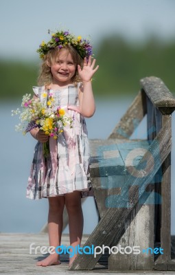 Little Girl With Flowers Stock Photo
