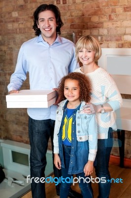 Little Girl With Parents Posing Casually Stock Photo