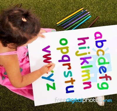 Little Girl Writing Alphabet Stock Photo