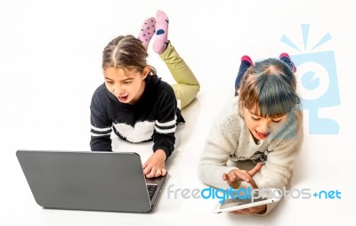 Little Girls Playing Games On The Notebook And Tablet Isolated On White Stock Photo