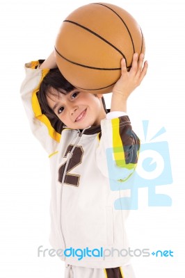 Little Kid While Throwing The Basketball Stock Photo
