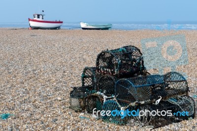 Lobster Pots And Fishing Boats On The Beach At Dungeness Stock Photo